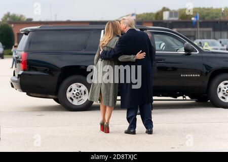 Washington, United States Of America. 27th Oct, 2020. President Donald J. Trump and First Lady Melania Trump embrace as he escorts her to her motorcade vehicle Tuesday, Oct. 27, 2020, at Joint Base Andrews, Md People: President Donald J. Trump and First Lady Melania Trump Credit: Storms Media Group/Alamy Live News Stock Photo