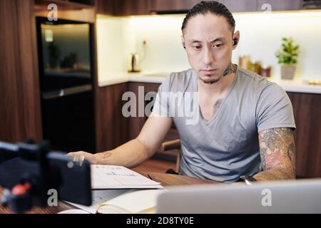 Frowning businessman with documents Stock Photo