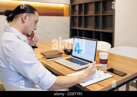 Man analyzing financial statistics Stock Photo