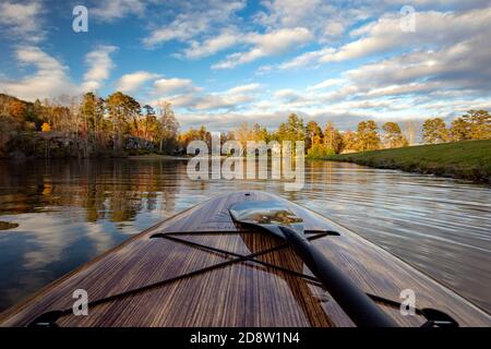 View of Straus Lake from paddle board in autumn - Brevard, North Carolina, USA Stock Photo