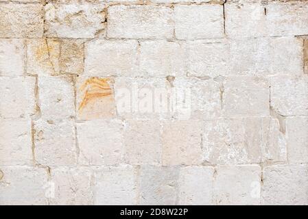 Wall of ancient building made with bricks on city street Stock Photo