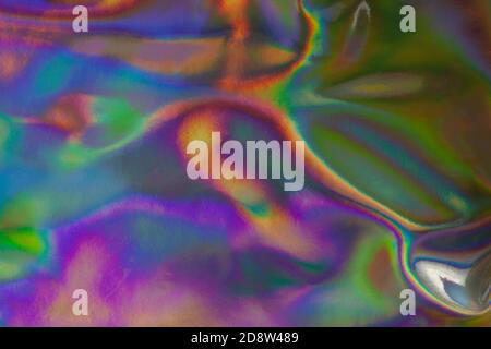 Abstract textured holographic background from leather surface. Trendy multicolor texture with copy space for text. Celebration, holidays, fashion conc Stock Photo