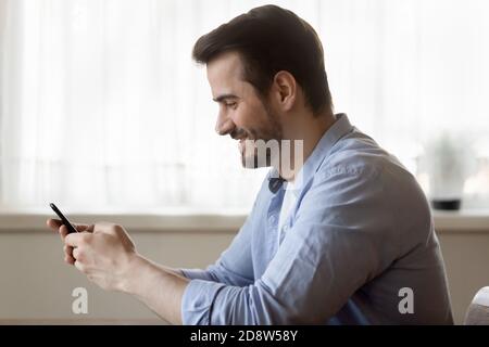 Happy smiling young man making call by smartphone Stock Photo