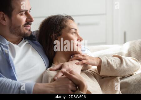 Caring young spouses spending free time at home together Stock Photo