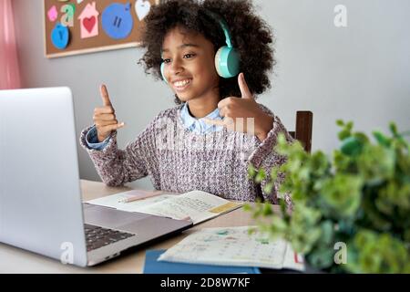 African mute kid girl showing sign language gesture learning online. Stock Photo