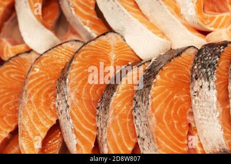 Chilled salmon steaks laid on ice store counter. Slice, steak, peace of red  fish. Fresh cooled trout slices, chum. Salmon meat in supermarket and  seafood store. Healthy diet concept. Stock Photo