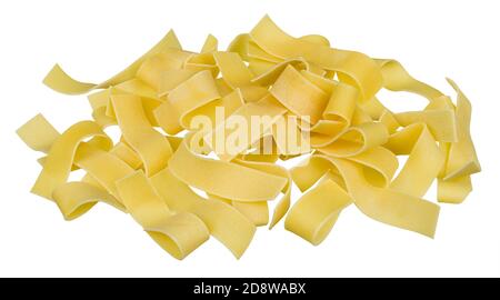 Wide uncooked noodles of egg pasta on pile. Close-up of raw rolled flat tagliatelle strips of wheat flour dough. Staple food. Italian or Asian cuisine. Stock Photo