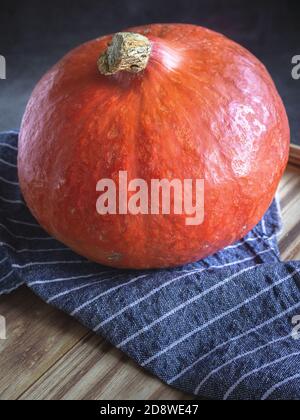 Pumpkin on wooden background and blue napkin Stock Photo