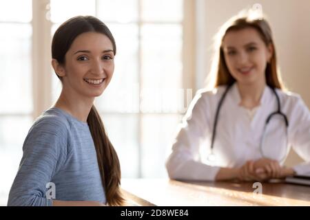 Portrait of happy patient in office of capable qualified doctor Stock Photo