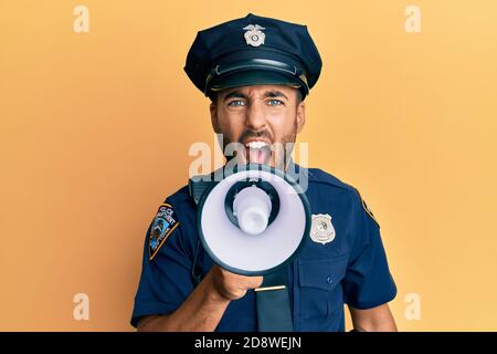 American police officer shouting through megaphone, yelling and protesting Stock Photo