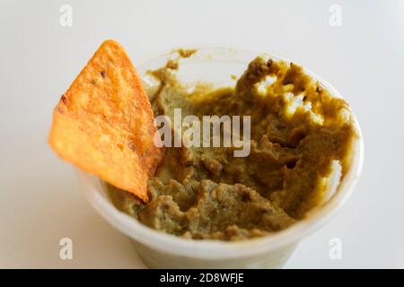 Guacamole with nachos on white background Stock Photo