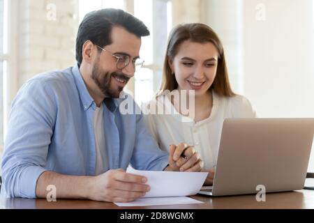 Glad happy business partners man and woman collaborating on project Stock Photo