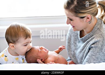 family in bedroom with his newborn baby daughter Stock Photo