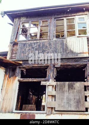 A fragment of an old burnt wooden house. Accident. Emergency Stock Photo