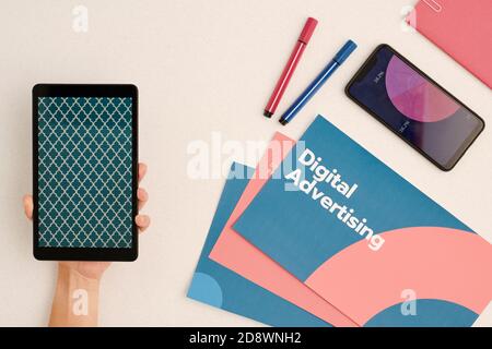 Flatlay of hand of contemporary businessperson holding smartphone with pattern Stock Photo