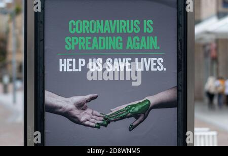 Coronavirus is spreading again help us save lives sign by the Scottish Government in October 2020 during the second wave, Airdrie, Scotland, UK Stock Photo