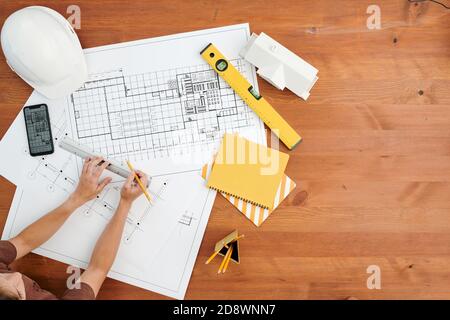 Top view of hands of contemporary female engineer or architect drawing sketch Stock Photo