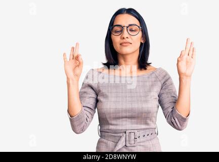 Young beautiful latin woman wearing casual clothes relax and smiling with eyes closed doing meditation gesture with fingers. yoga concept. Stock Photo