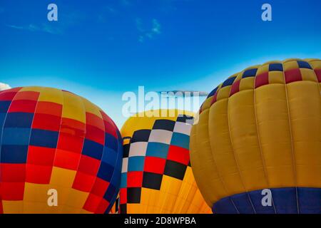 three multicolored balloons against the blue sky Stock Photo