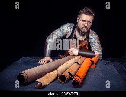 Leather cutter demostrating leather cutting process Stock Photo