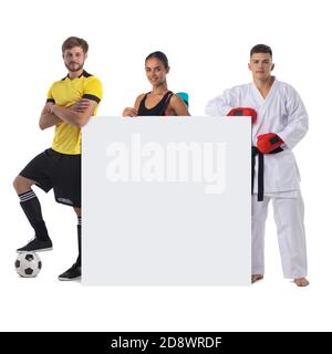 Group of sports people presenting empty banner with copy space for text isolated on white background Stock Photo