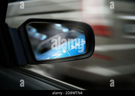 Police car chase pursuit in car mirror chasing speeder speeding racing traffic crime getaway escape Stock Photo