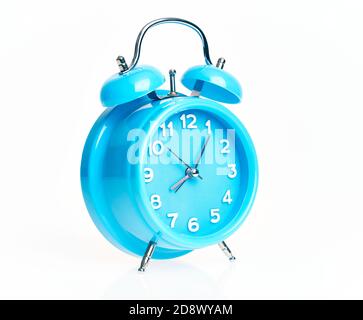 Hand of hispanic man holding blue alarm clock over isolated white background. Stock Photo