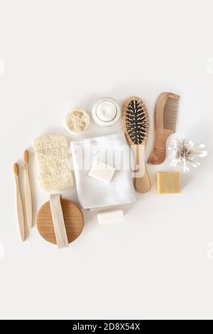 Zero waste concept. Set of eco friendly bathroom accessories on white background - natural soap, eco bag, bamboo toothbrush, natural hairbrush. Sustainable, eco-friendly lifestyle. Stock Photo