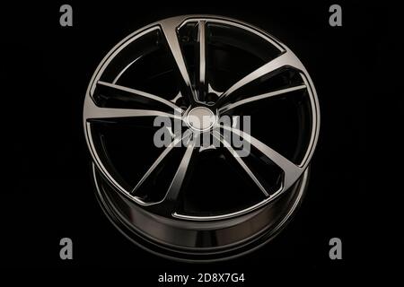 black stylish rim alloy wheel on a dark background. close-up, front view Stock Photo