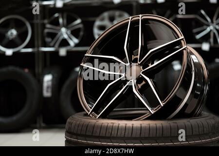 Light large sports alloy wheel on the background of a tire store, close-up Stock Photo