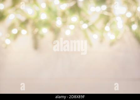 christmas tree frame with spruce twigs decorated with garland lights, blurry holiday background Stock Photo