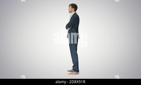 Wide shot. Side view. Confident businessman showing thumbs up and ok gestures on gradient background. Professional shot in 4K resolution. 047. You can Stock Photo