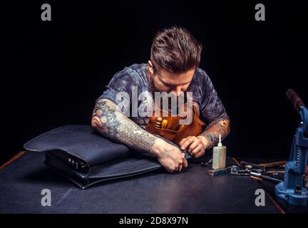 Leather workman produces a good product at his studio Stock Photo