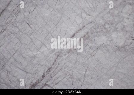 Smoky gray marble with dark veins and blotches, close-up of a flat surface of natural stone. Background, texture. Stock Photo