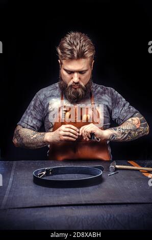 Leather Currier producing a good product at his shop Stock Photo