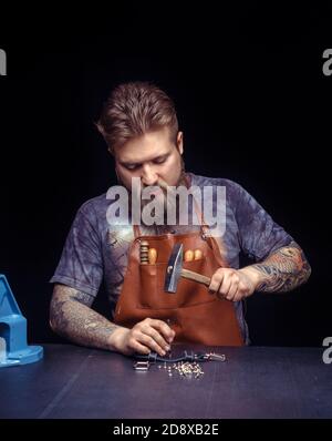 Leather Artisan being keen on his buisness at leather shop Stock Photo