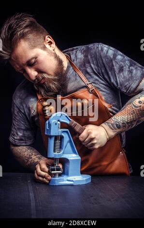 Currier forms new leather product in the place of work Stock Photo