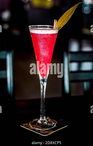 a red cocktail made from mulled wine and served in a tall glass Stock Photo