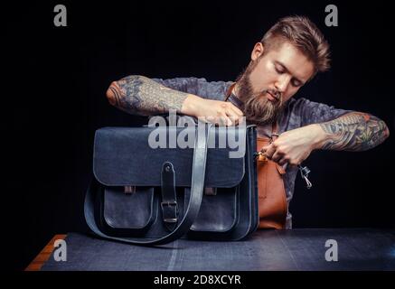 Leather Professional performs leather working for a new product Stock Photo