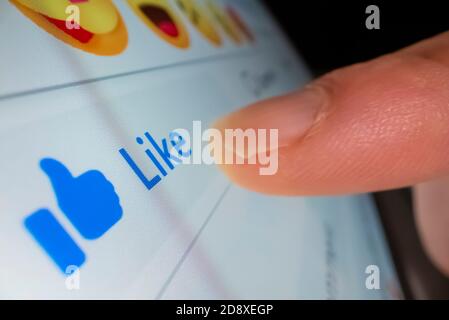 Macro shot of clicking the like button in Facebook Stock Photo
