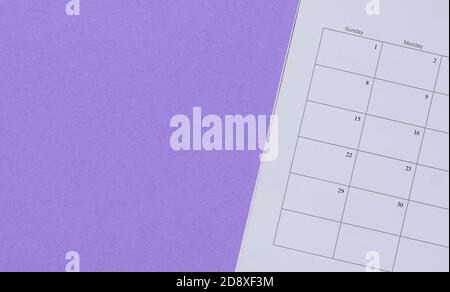 Calendar on purple background. Top view. Copy space. Stock Photo