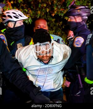 Metropolitan (DC) Police officers arrested a man after he rattled a barricade at a protest over the death of Karon Hylton, Washington, DC, USA Stock Photo