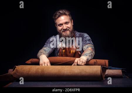 Leather Craftsman working on a new leather product Stock Photo