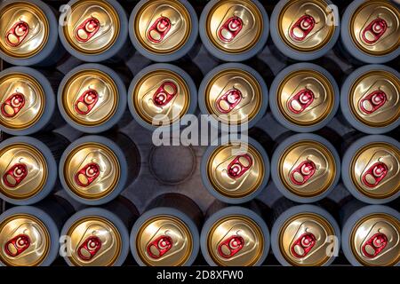 opened canned beer and many unopened Tin beer cans top view Stock Photo
