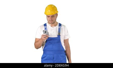 Medium shot. Factory worker employee chatting browsing texting on smartphone on white background. Professional shot in 4K resolution. 014. You can use Stock Photo
