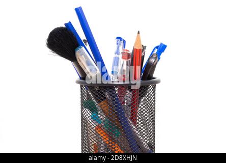 Pen, color pencils, Brush in a stand over the white background, Stock Photo
