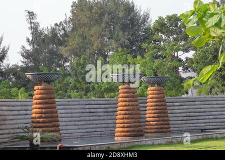 Stone wall, steps and planter. Colorful, landscaped garden with plant pot Stock Photo