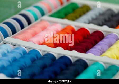 A set of threads in different colors. Multicolored threads for sewing and needlework. Small rolls of thread in a different colours.  Stock Photo