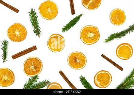 Composition of cinnamon, fur tree branches and dried oranges on white background. Flat lay, top view. Copy space for your design. Christmas or New Yea Stock Photo