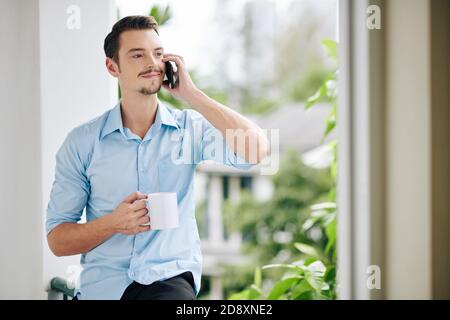 Positive man talking on phone Stock Photo
